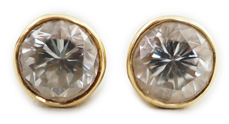 A pair of 18ct gold and collet set solitaire diamond ear studs